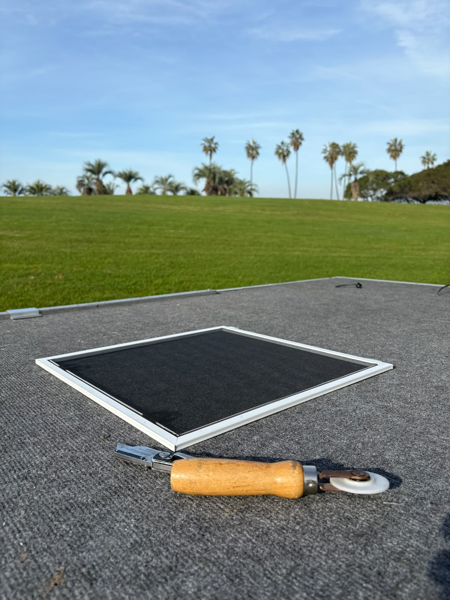 Freshly built window screen with spline roller tool