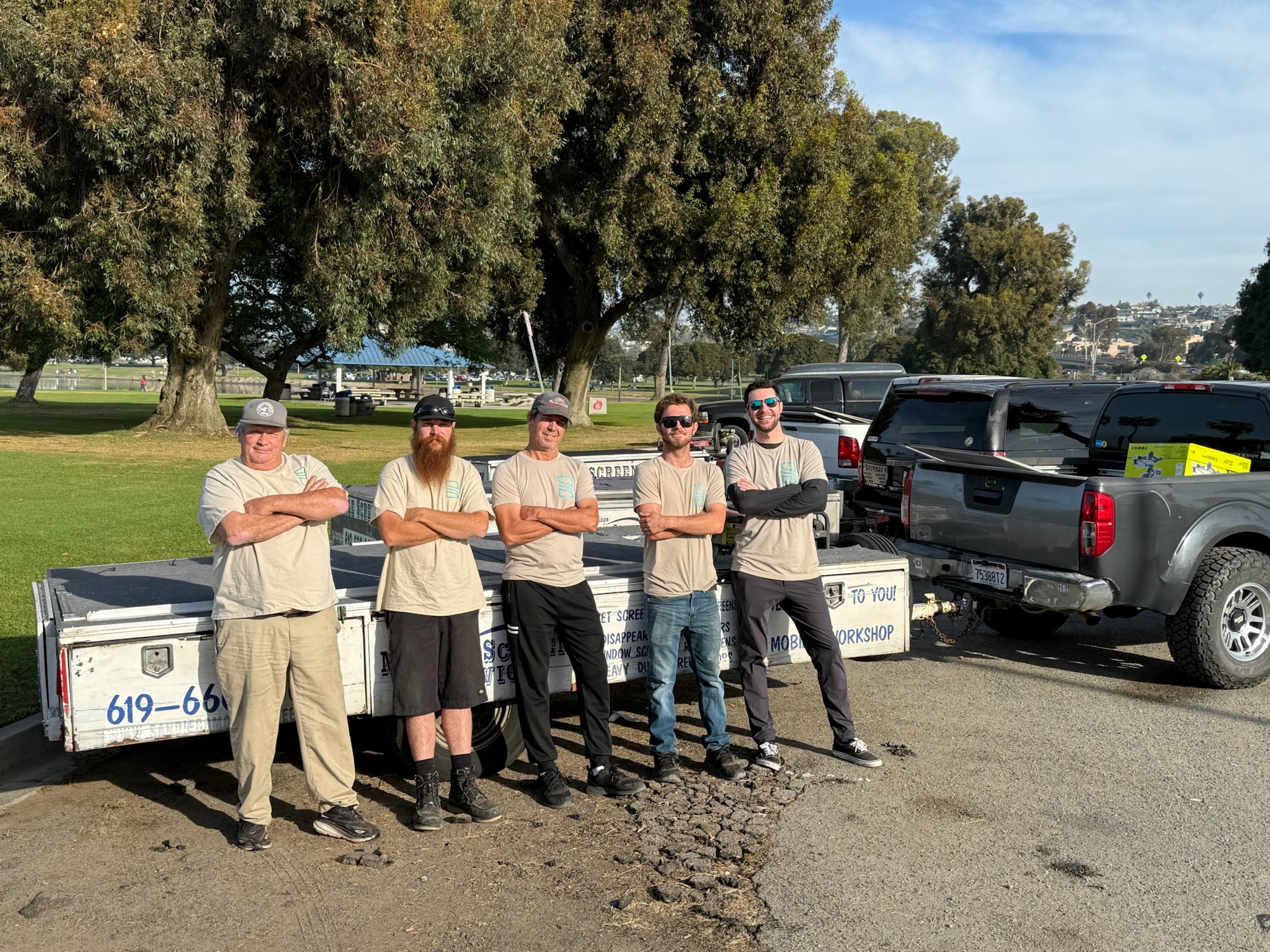 San Diego Mobile Screens team standing in front of mobile workshop trailers